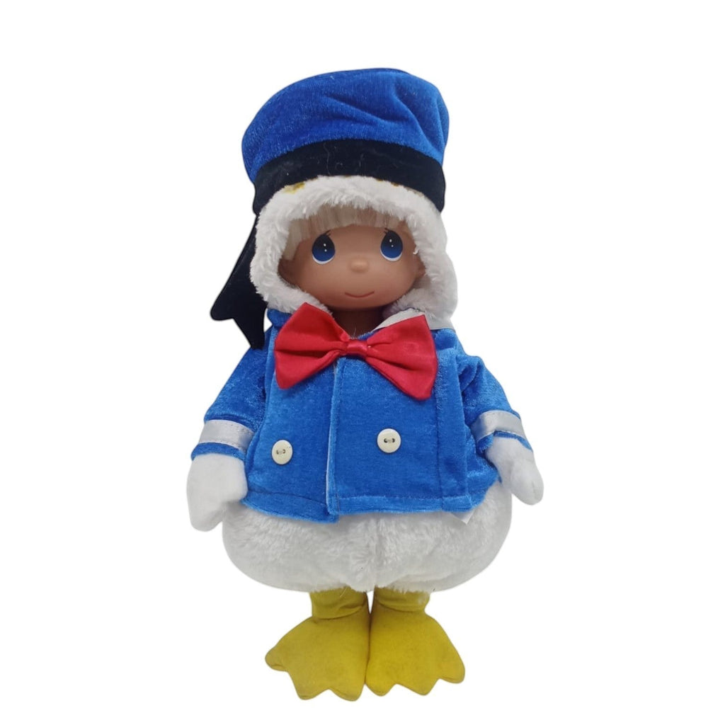 The Doll Maker 12-inch collectible vinyl doll in a Donald Duck outfits featuring a blue sailor jacket with a red bow tie and a blue hat
