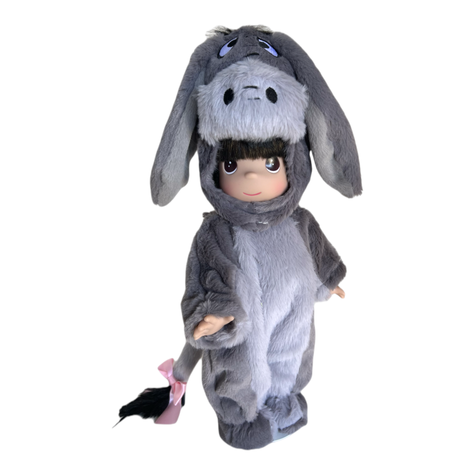 The Doll Maker 12-inch collectible doll wearing a plush grey Eeyore donkey costume with a pink bow on the tail