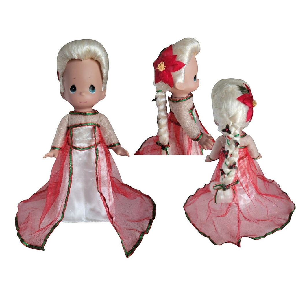 The Doll Maker Elsa Queen 12-inch doll with blonde hair, red poinsettia hair accessory, and festive red and white gown.