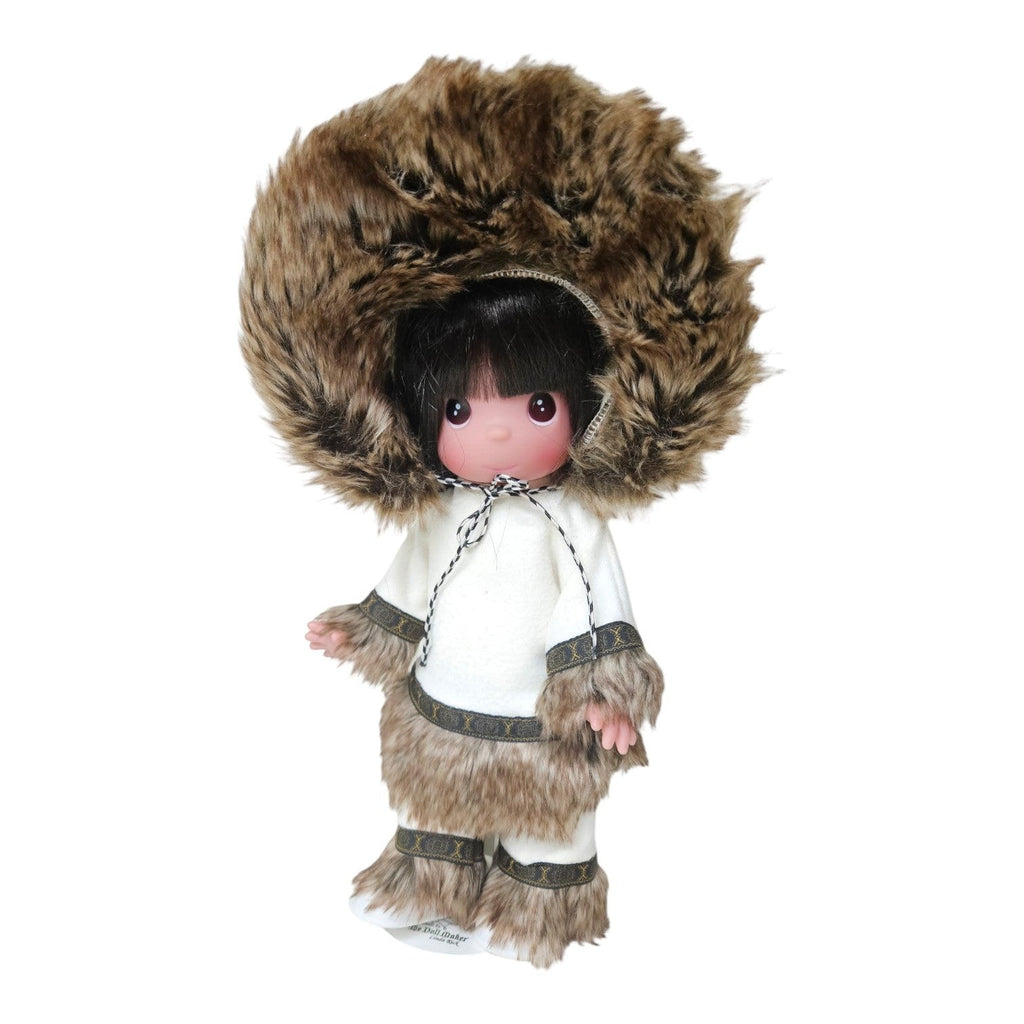 The Doll Maker 12-inch Eskimo doll wearing a white tunic and pants with faux fur trim and a large fur-lined hood.