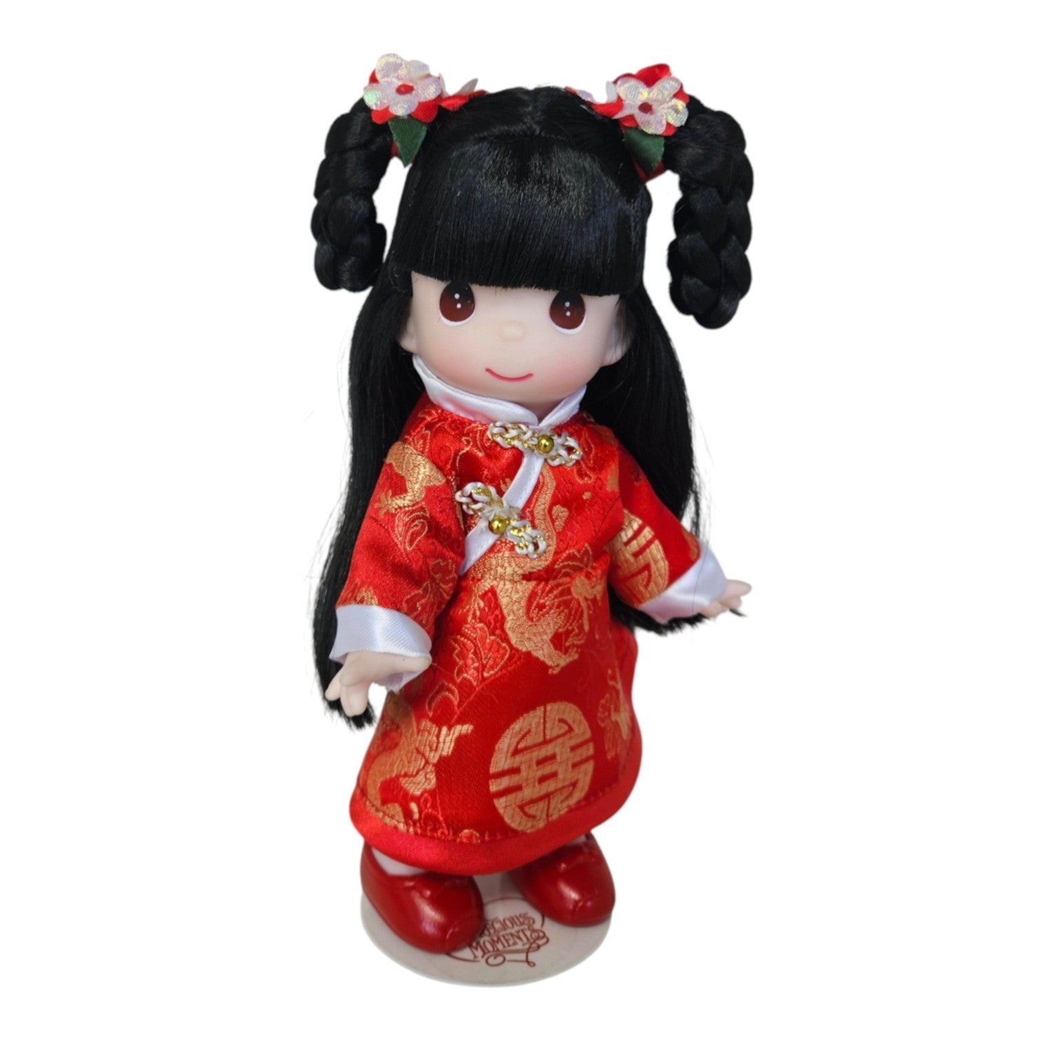 The Doll Maker 9-inch Fai Ting doll wearing a traditional red and gold Lunar New Year dress with floral hair accessories