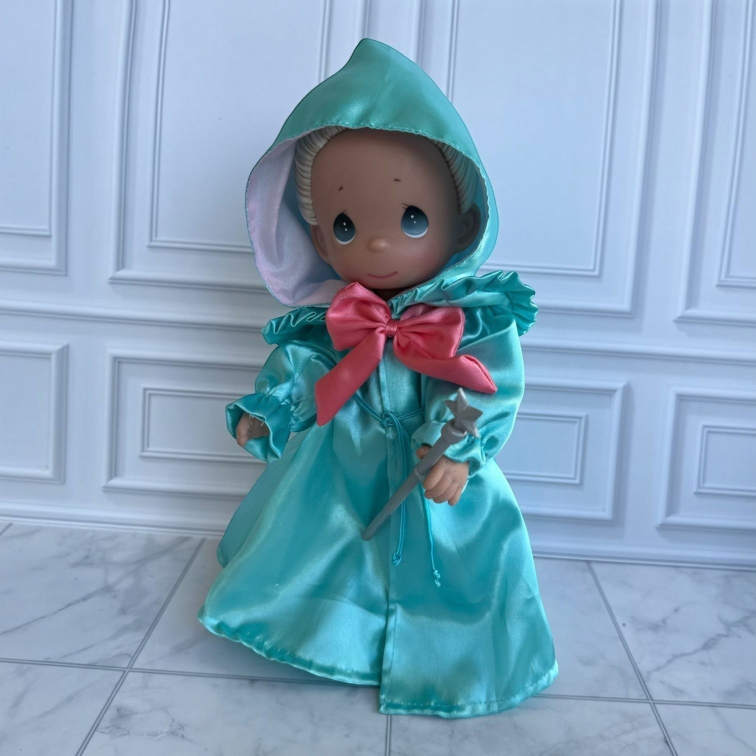 The Doll Maker 12-inch Fairy Godmother doll in a teal satin hooded gown with a pink bow and silver star wand