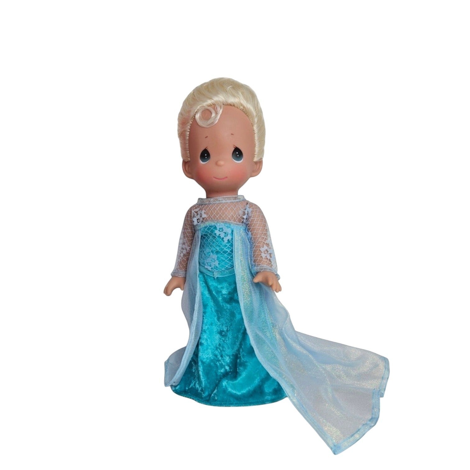 The Doll Maker 12-inch Frozen Elsa doll with blonde hair wearing a signature ice-blue gown with a sheer cape.
