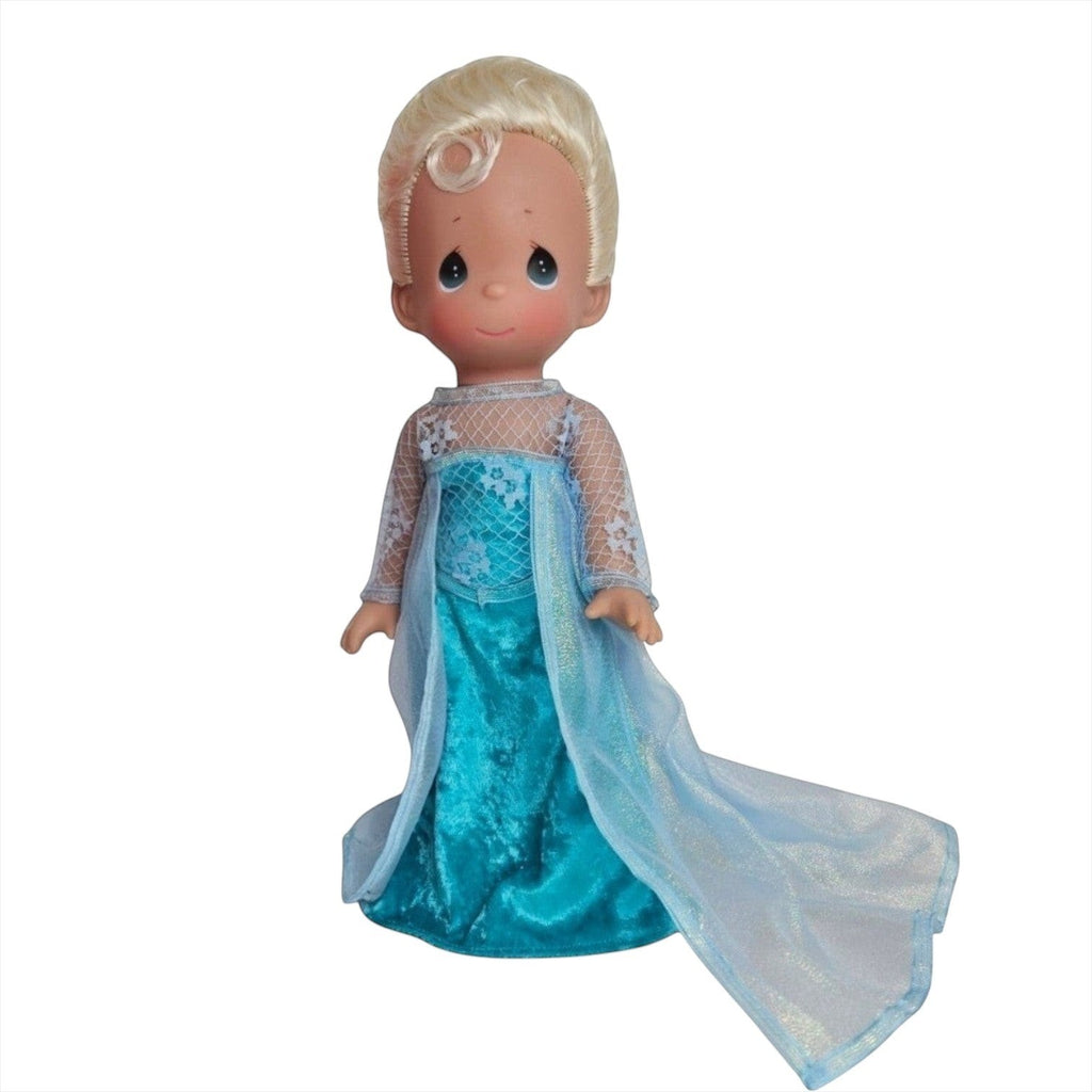 The Doll Maker 12-inch Frozen Elsa doll with blonde hair wearing a signature ice-blue gown with a sheer cape.