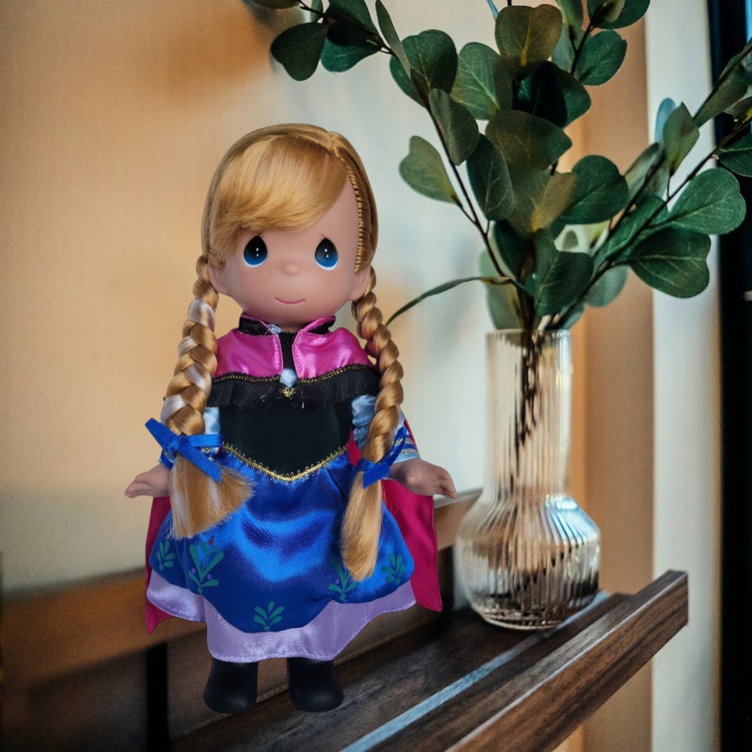 The Doll Maker 12-inch Frozen Princess Anna collectible doll with blonde braided hair and signature royal outfit