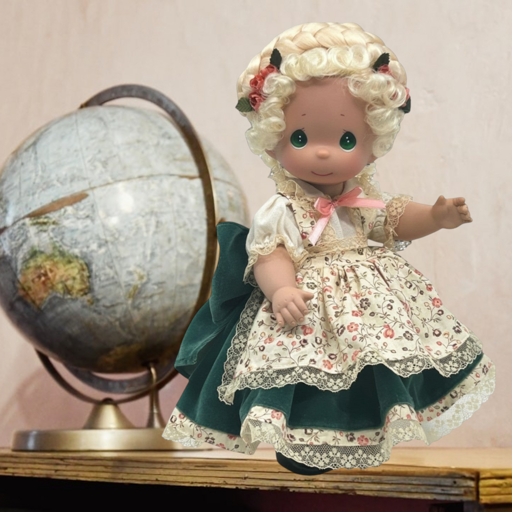 The Doll Maker 12-inch German collectible doll in traditional Bavarian dirndl with floral apron and blonde braided hair