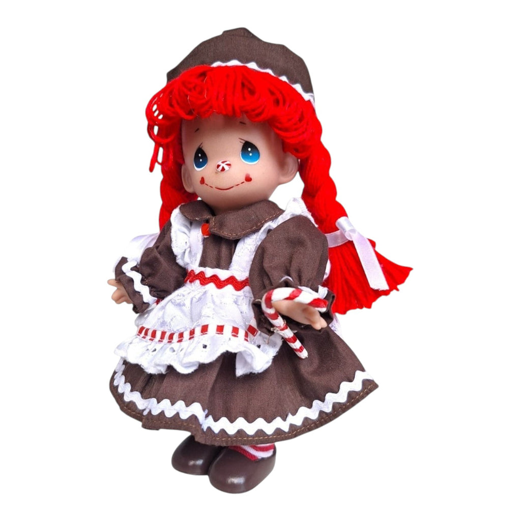 The Doll Maker 7-inch Raggedy Ann vinyl doll wearing a brown gingerbread-themed dress with white lace trim