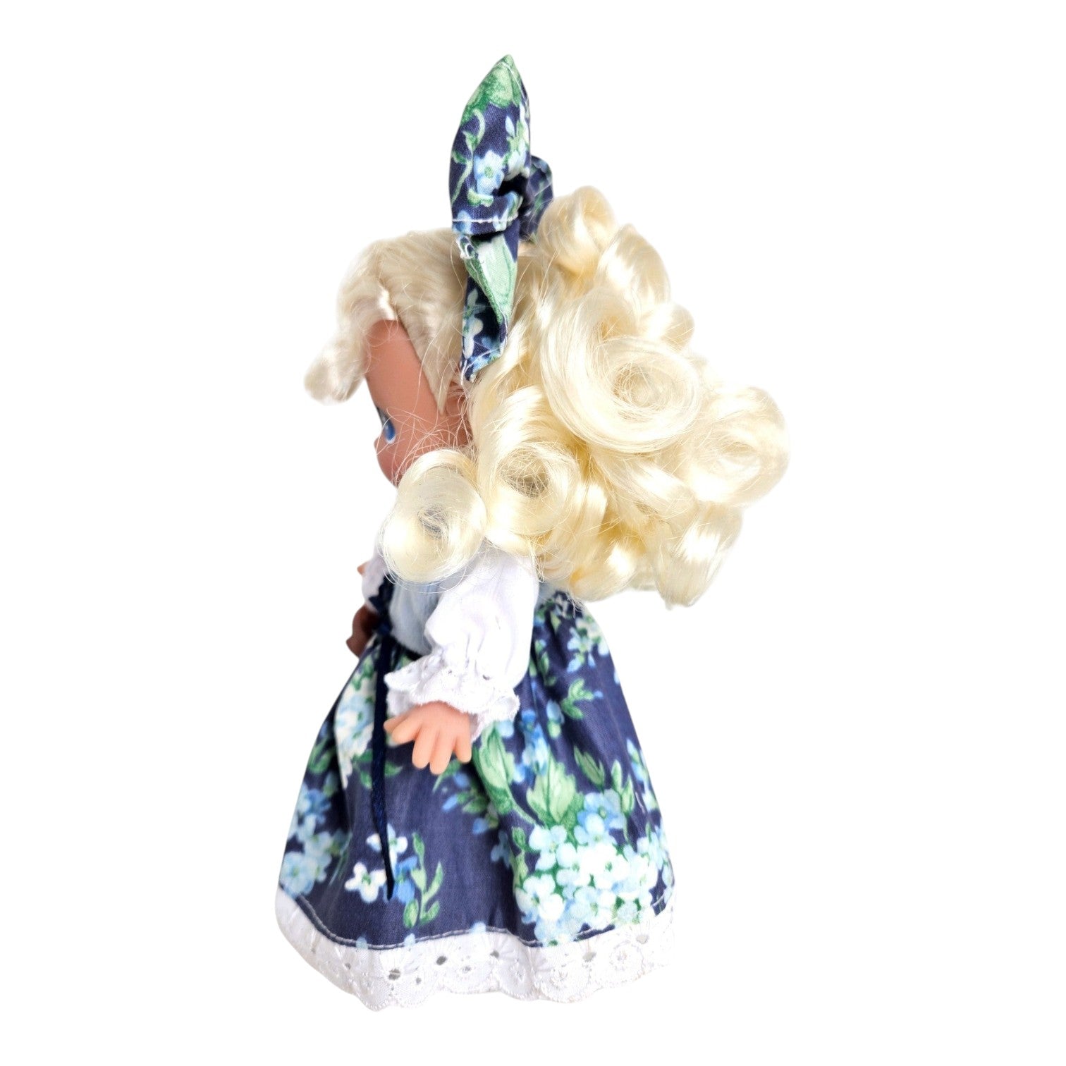 The Doll Maker 7-inch Goldilocks vinyl doll with blonde curly hair wearing a blue floral dress and matching bow