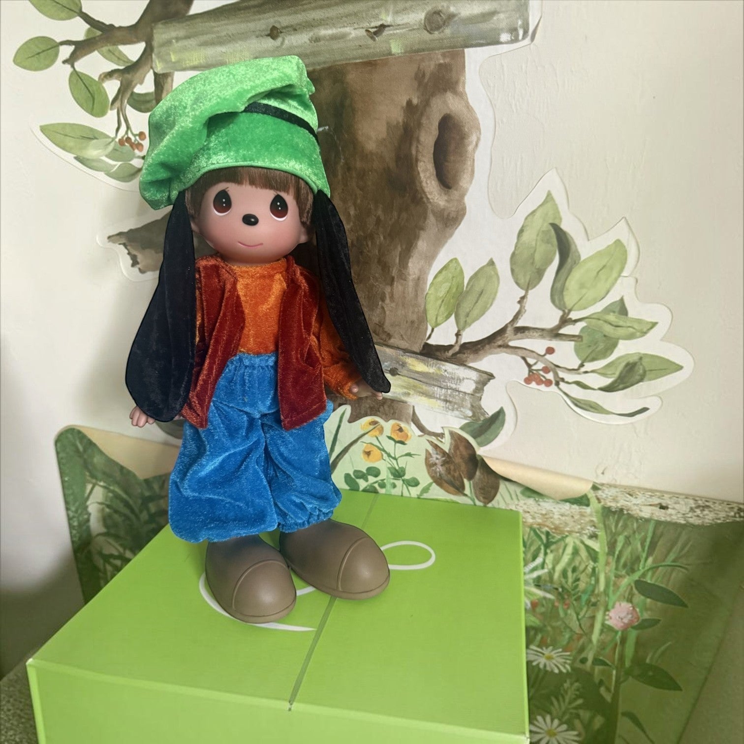 The Doll Maker 12-inch Goofy collectible doll wearing a green hat, and blue trousers with large shoes