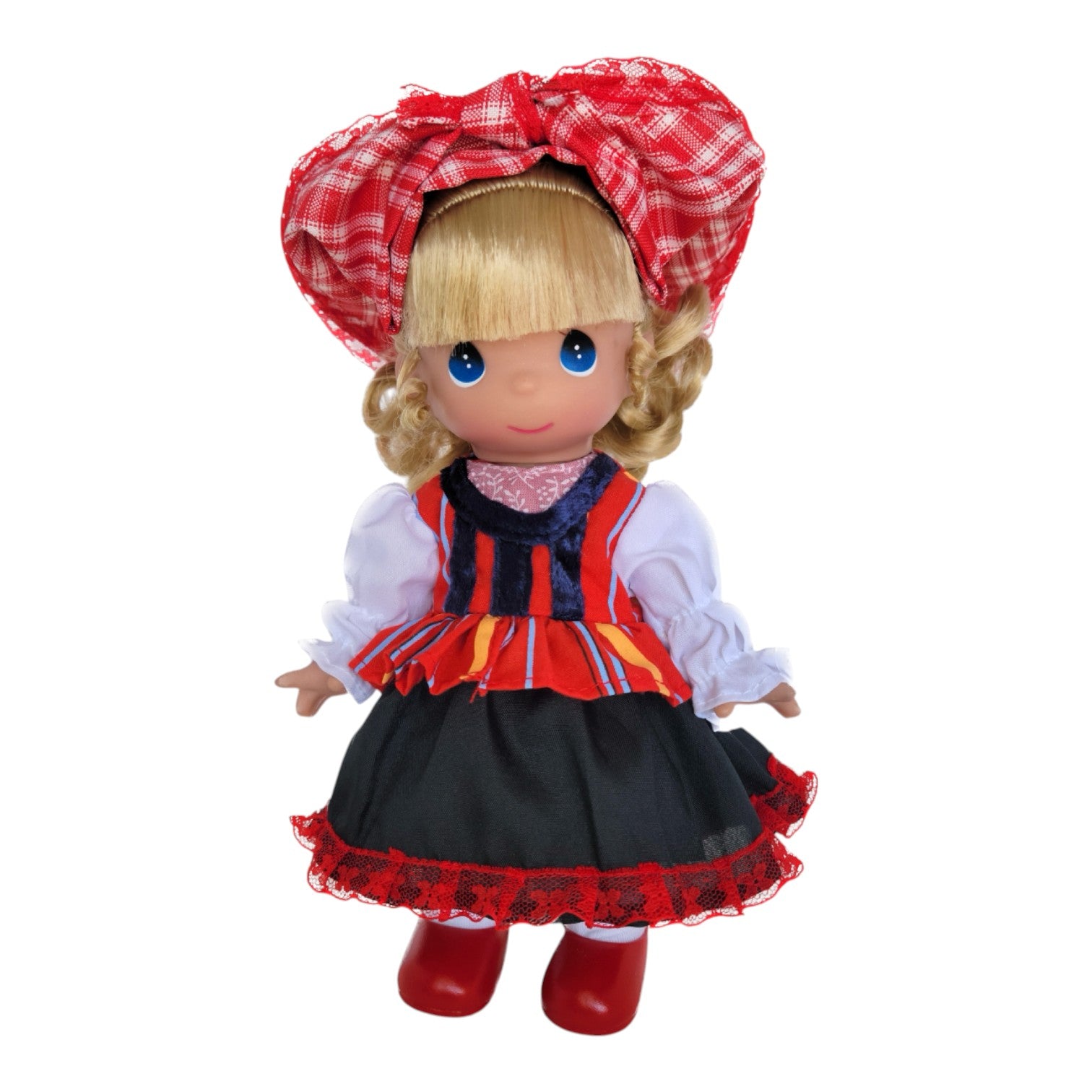 The Doll Maker Hajna 9 inch vinyl doll wearing a traditional Hungarian costume with a red plaid headpiece