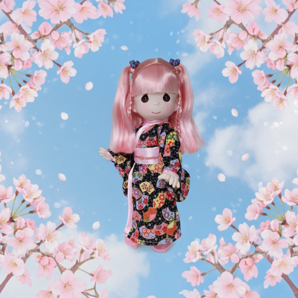 The Doll Maker Haruka doll with pink hair wearing a patterned kimono, framed by cherry blossoms against a blue sky.