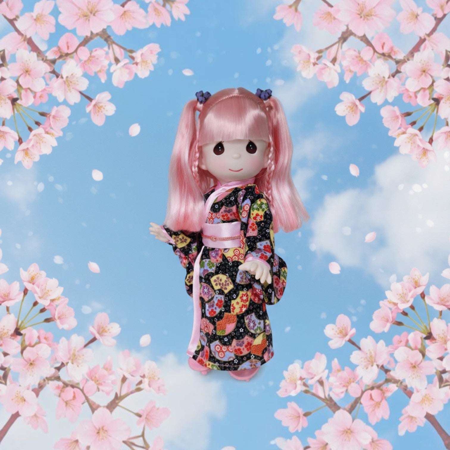 The Doll Maker Haruka doll with pink hair wearing a patterned kimono, framed by cherry blossoms against a blue sky.