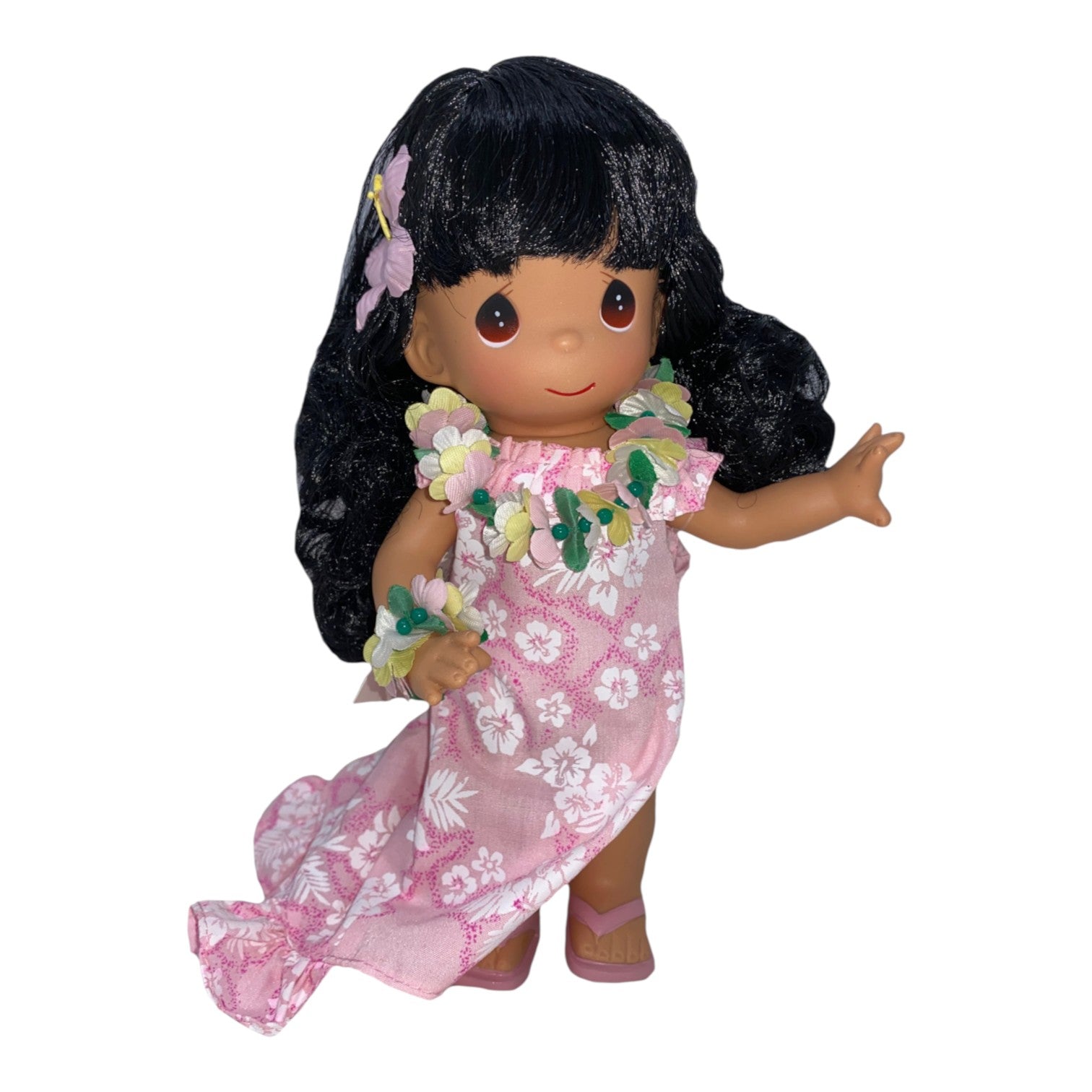 The Doll Maker Hawaii Leina’ala 9-inch doll wearing a pink floral dress, flower lei, and hair accessory