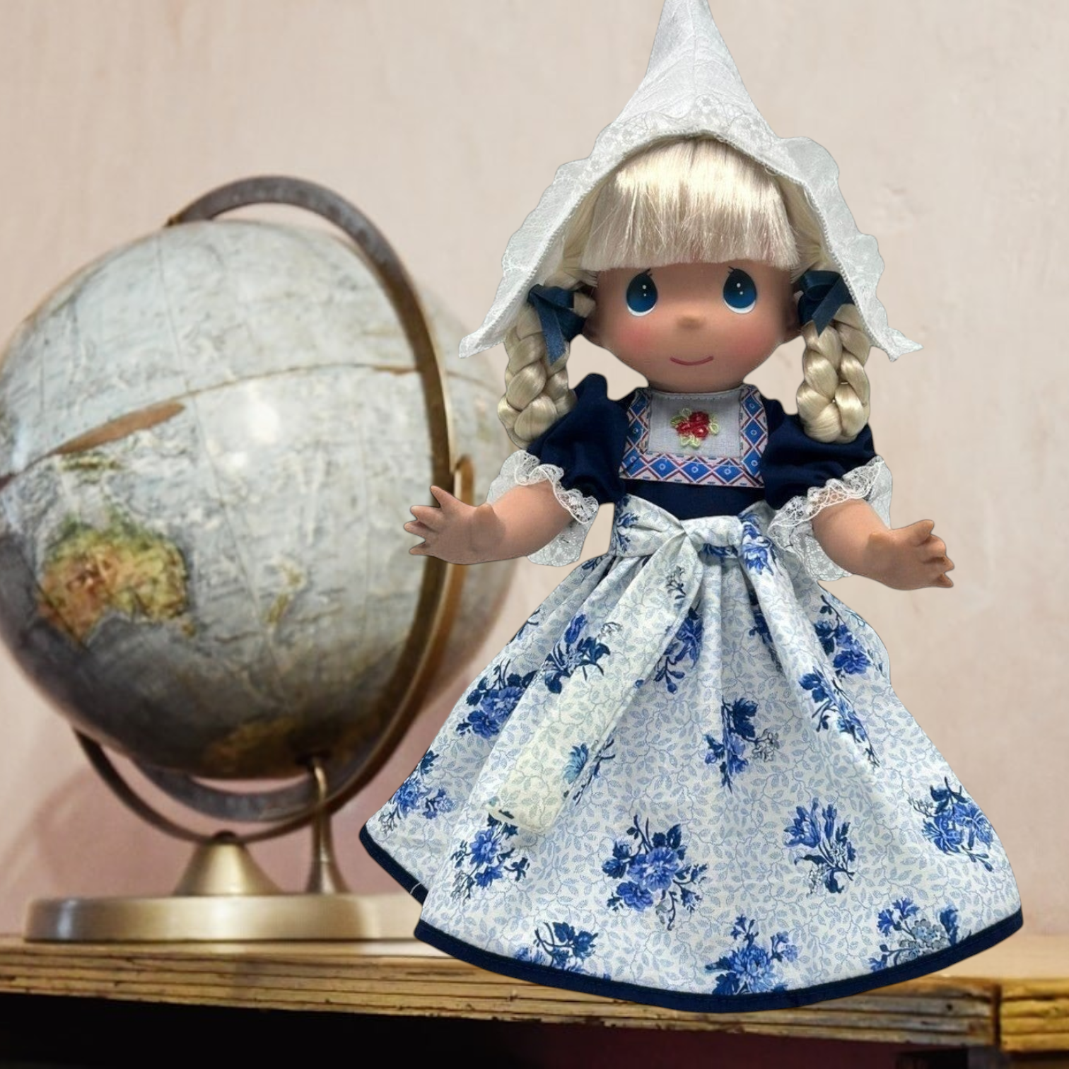 The Doll Maker 12-inch Holland collectible doll wearing a traditional Dutch costume with a white lace bonnet.