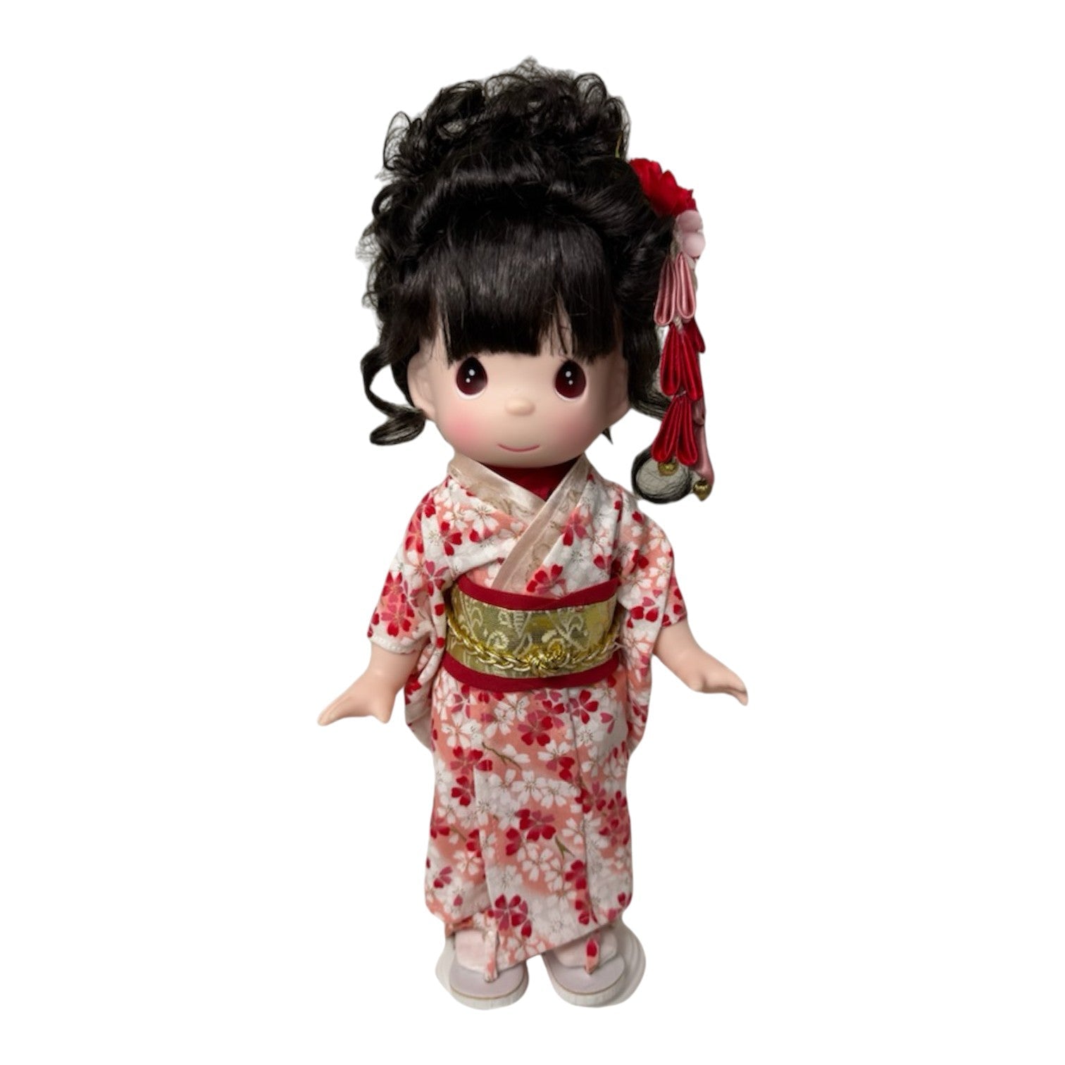The Doll Maker Honoka 12-inch Japanese Girl's Day doll wearing a floral kimono with a gold obi and hair accessory.
