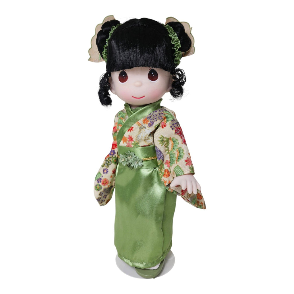 The Doll Maker Japanese Girl's Day doll wearing an elegant green floral kimono with fun hair styling.