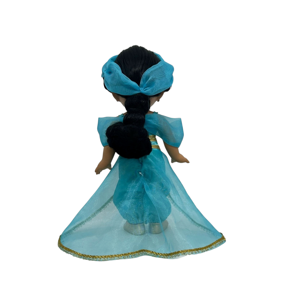 The Doll Maker Jasmine Elegance 12-inch doll seen from the back in a turquoise outfit with a flowing sheer cape.