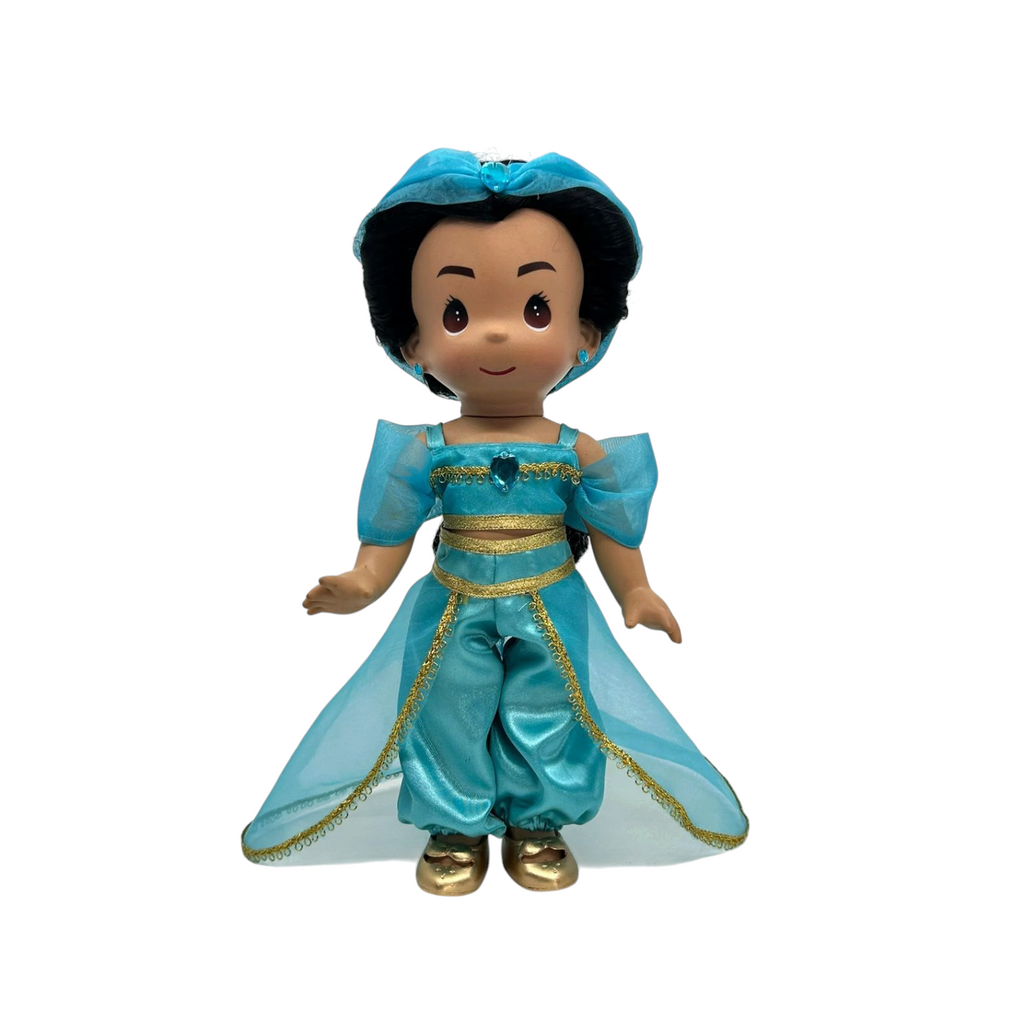 The Doll Maker Jasmine Elegance 12-inch vinyl doll wearing a turquoise outfit with gold trim and a matching headband.