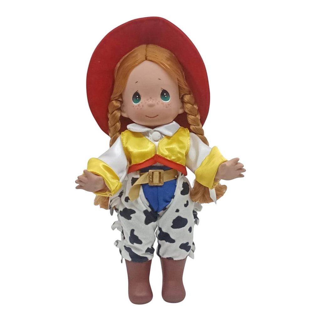 The Doll Maker 12-inch Jessie cowgirl doll from Toy Story featuring a red hat, yellow vest, and cow-print chaps.