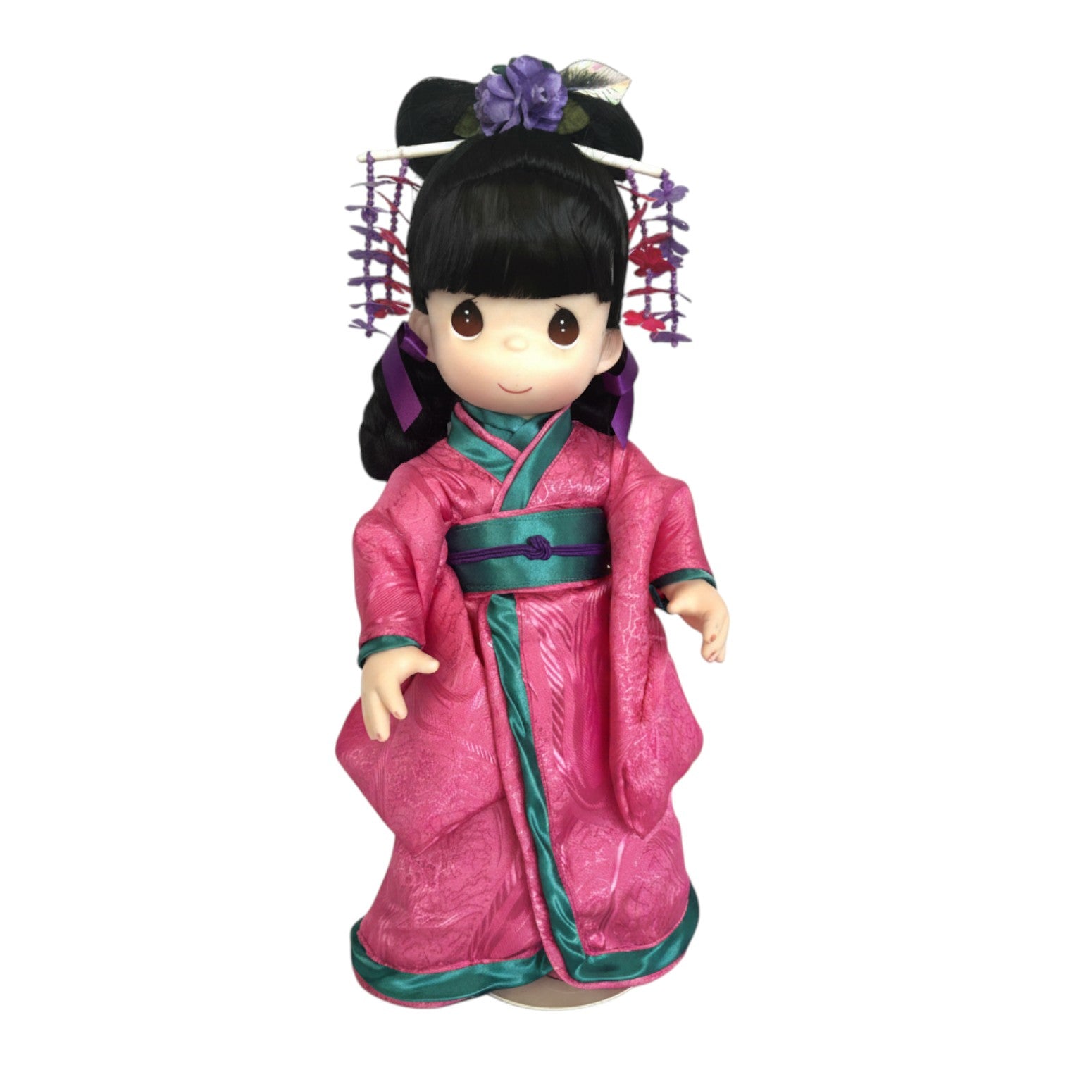 The Doll Maker 16-inch Kaoru Japanese Girl's Day doll wearing a bright pink kimono with teal trim and floral hairpiece