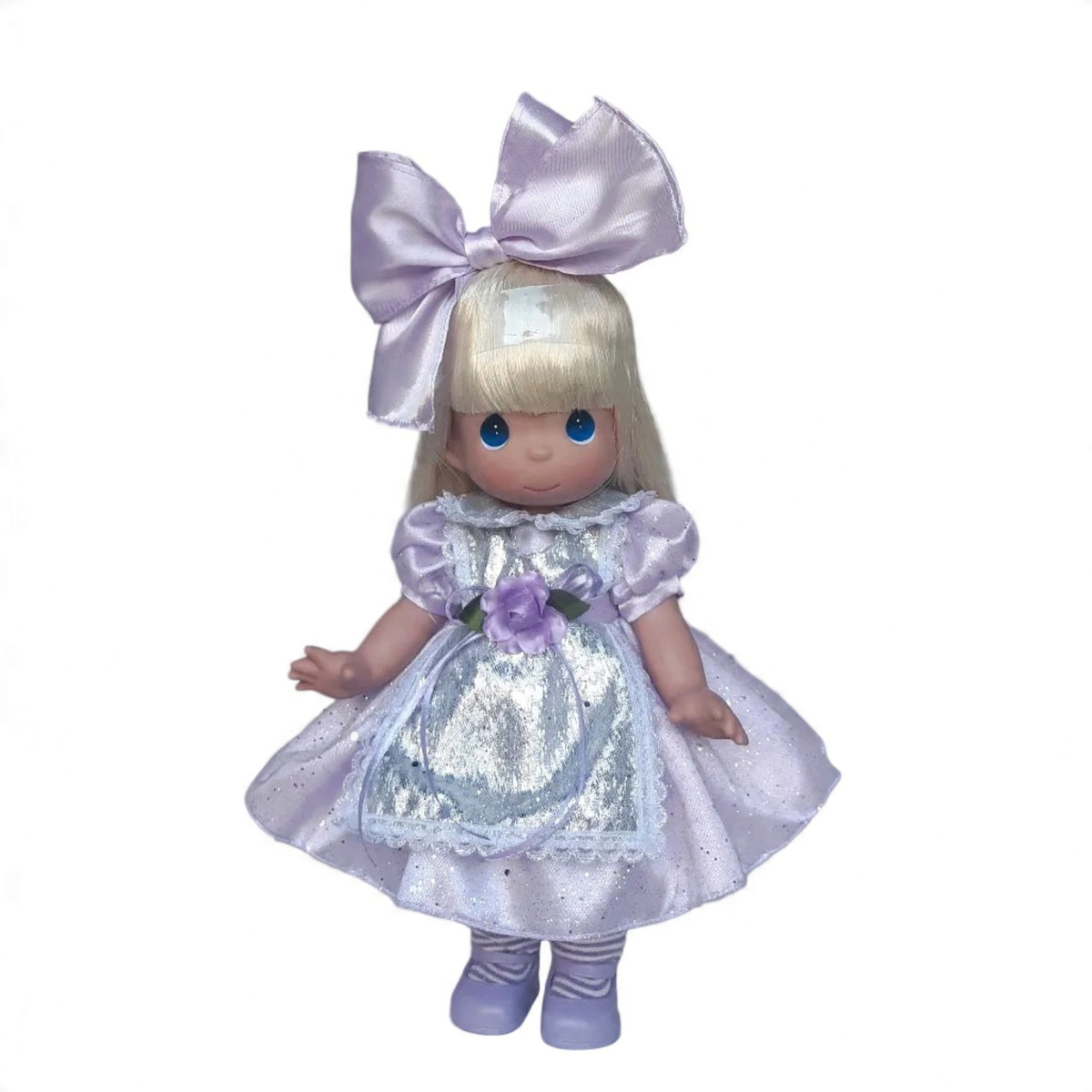 The Doll Maker 12-inch Lavender Alice doll wearing a shimmering lavender dress with a large bow and apron.