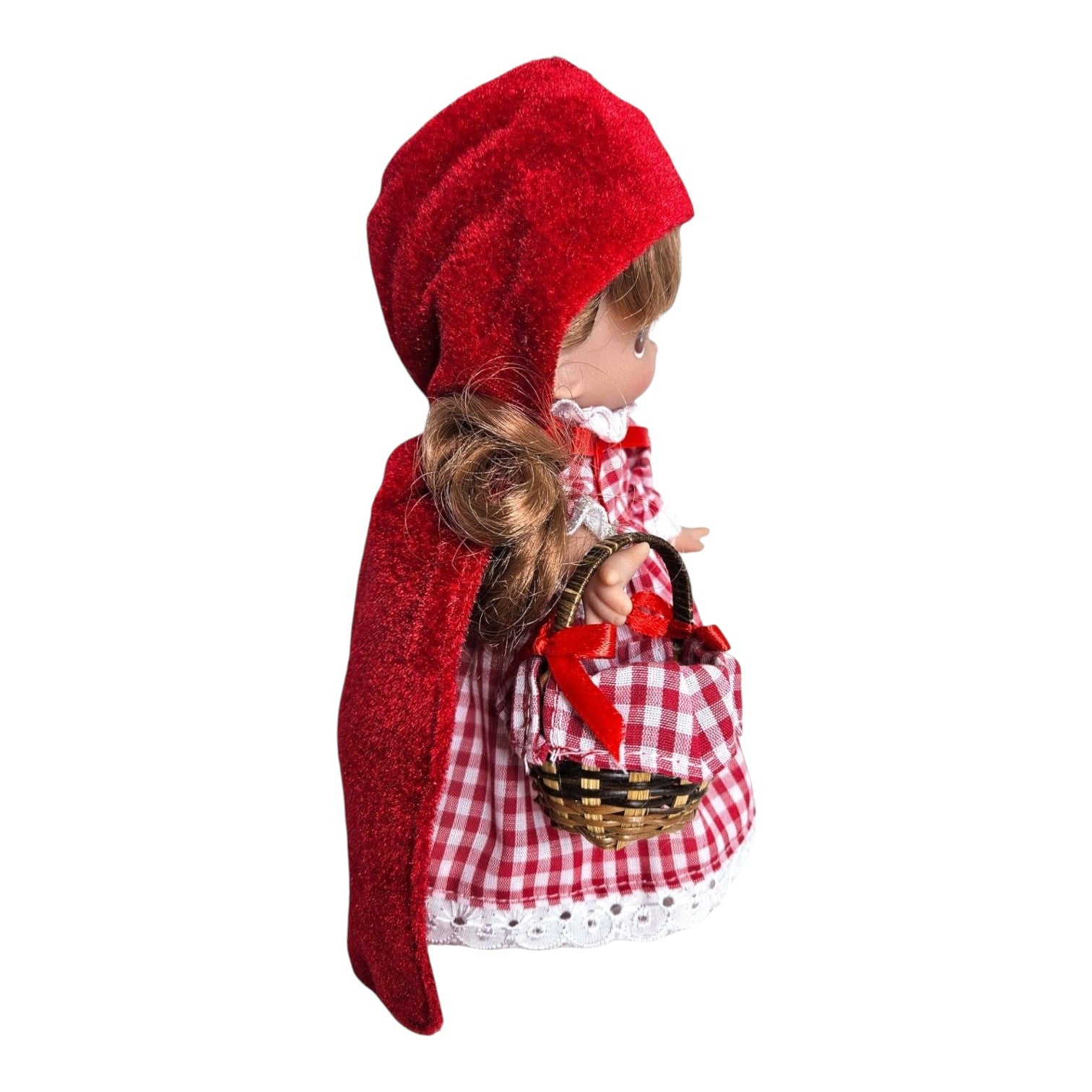 The Doll Maker 7-inch Lil Red Riding Hood vinyl doll wearing a red hooded cape and gingham dress with a small basket.