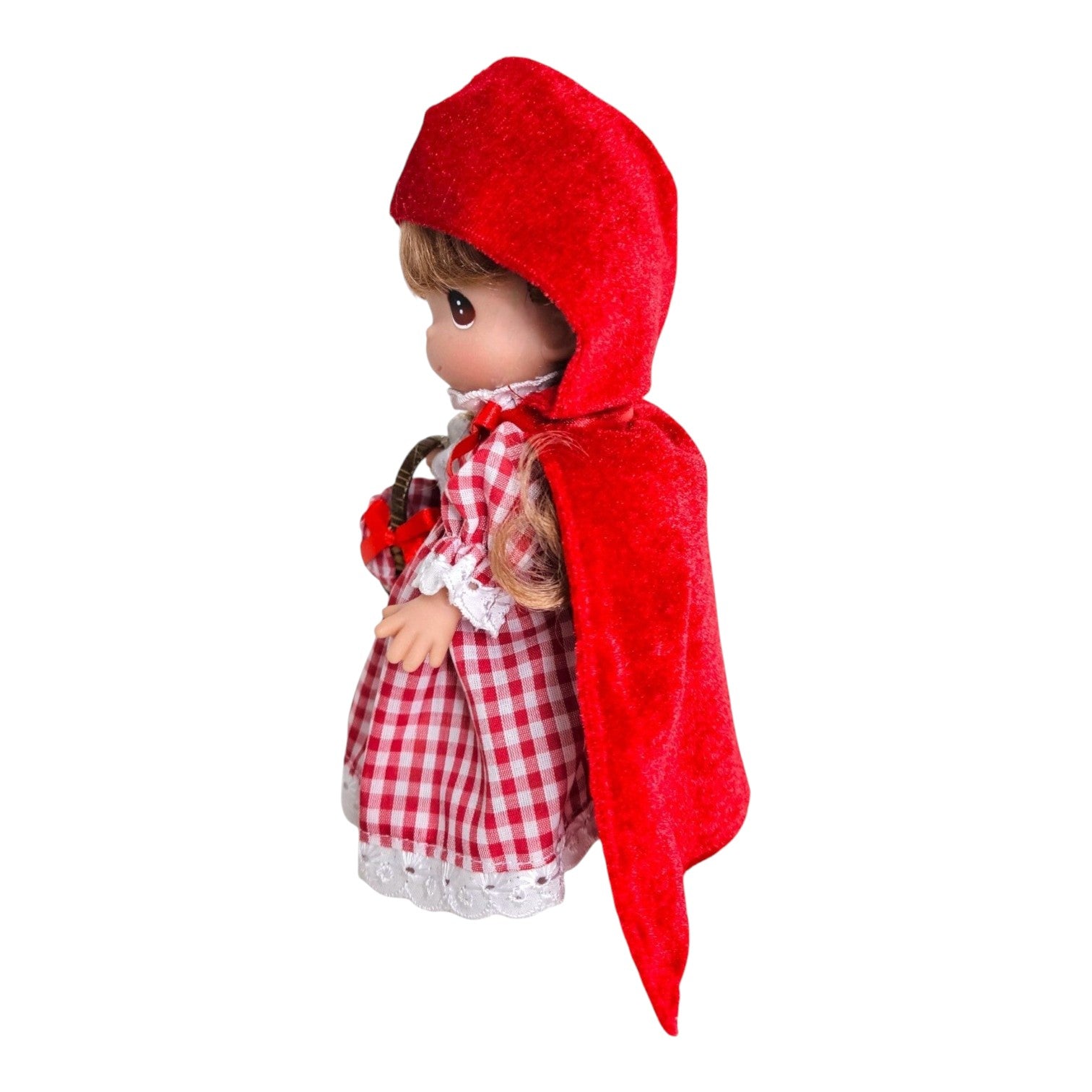 The Doll Maker 7-inch Lil Red Riding Hood vinyl doll wearing a red velvet hooded cape and red gingham dress.