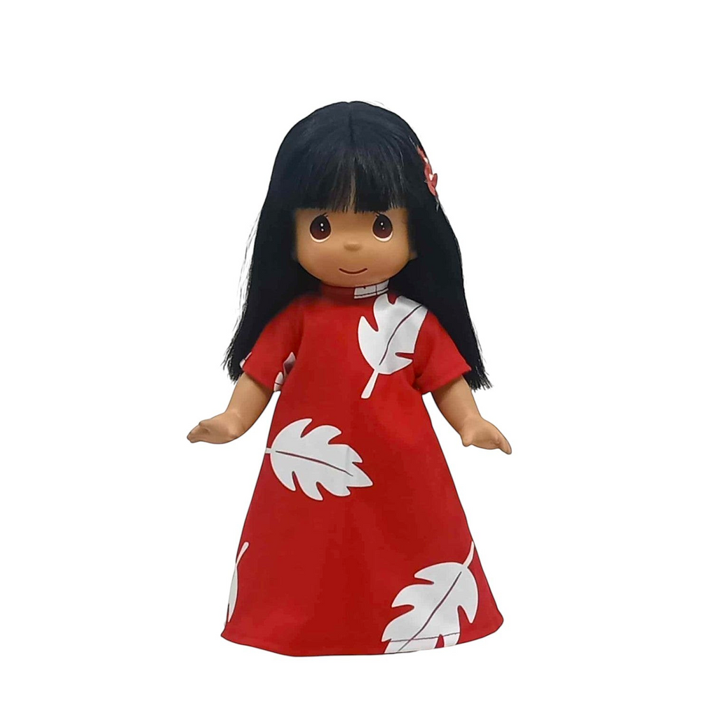 The Doll Maker 12-inch Lilo vinyl doll wearing a red dress with white leaf print and long black hair
