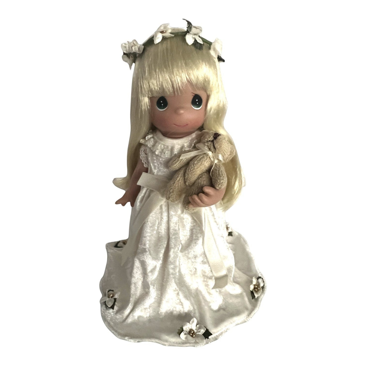 The Doll Maker 9-inch Linda doll with blonde hair wearing a white velvet dress and floral crown, holding a Charlie bear.