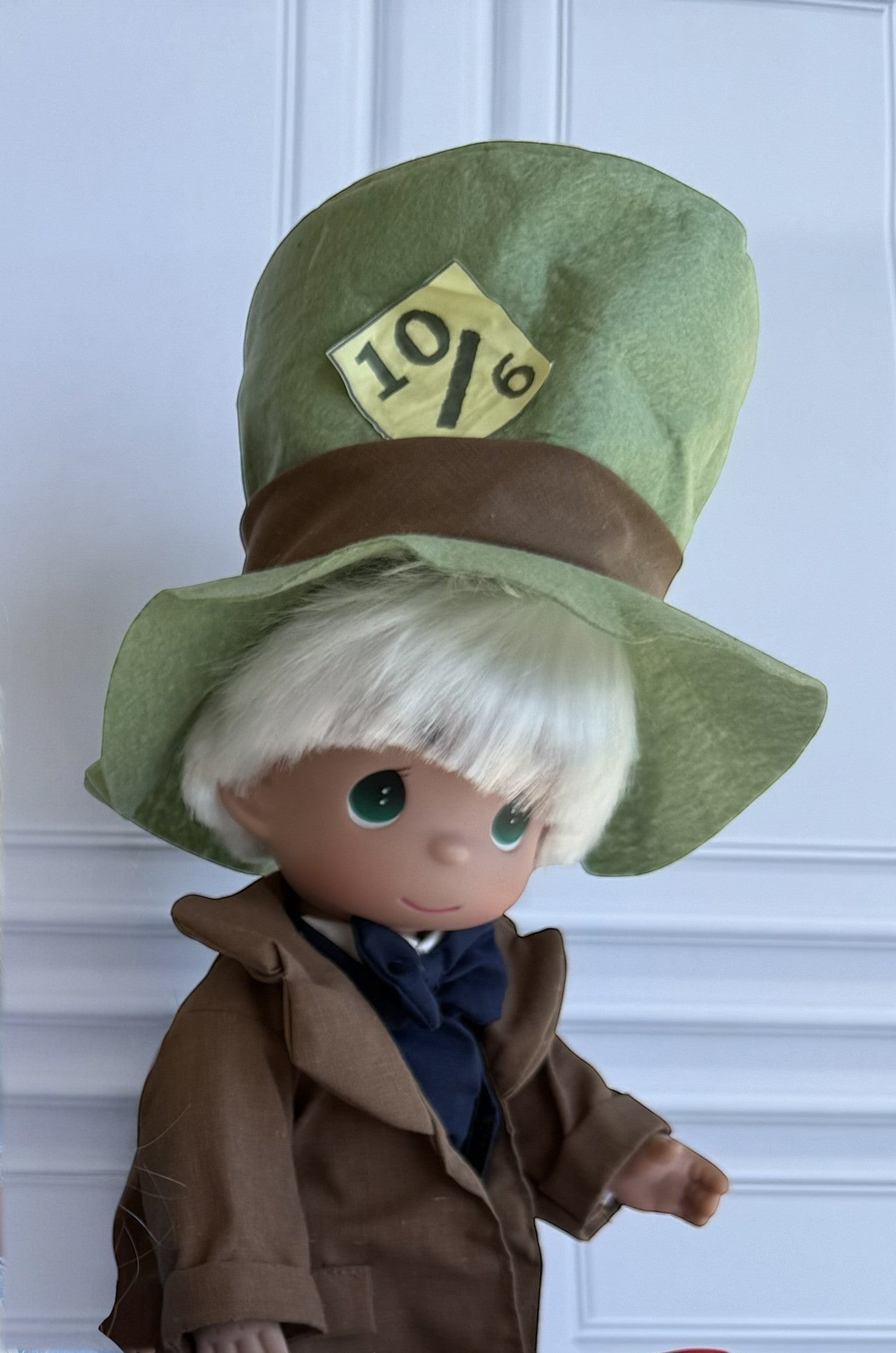 The Doll Maker 12-inch Mad Hatter doll wearing a signature green top hat and brown coat.