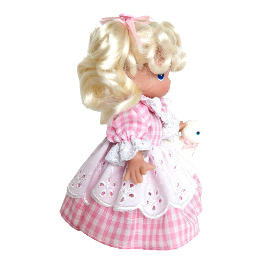 The Doll Maker Mary Had a Little Lamb 7-inch vinyl doll with blonde hair in a pink gingham dress holding a toy lamb.