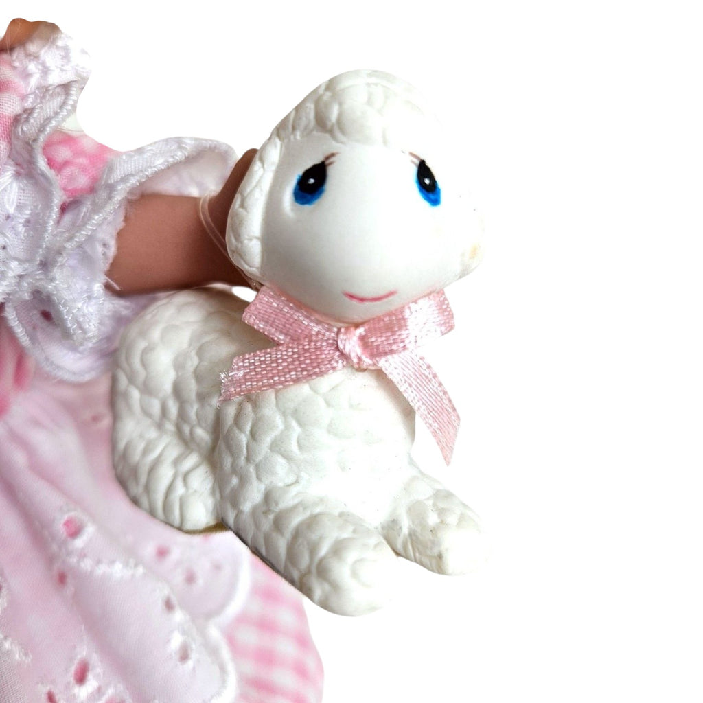 The Doll Maker Mary Had a Little Lamb doll holding a white vinyl lamb figurine with a pink ribbon bow