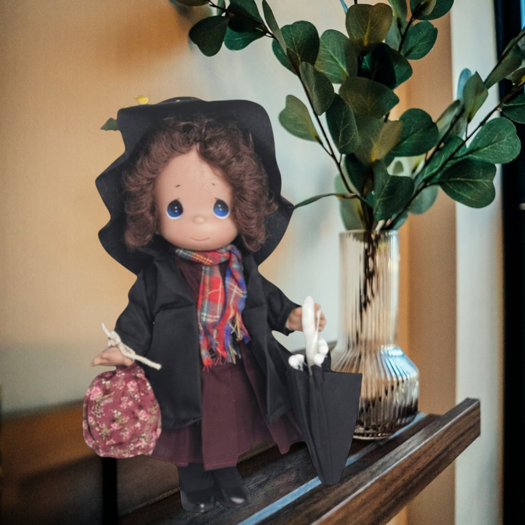 The Doll Maker 12-inch Mary Poppins Chimney Sweep collectible doll wearing a black coat, hat, and plaid scarf.