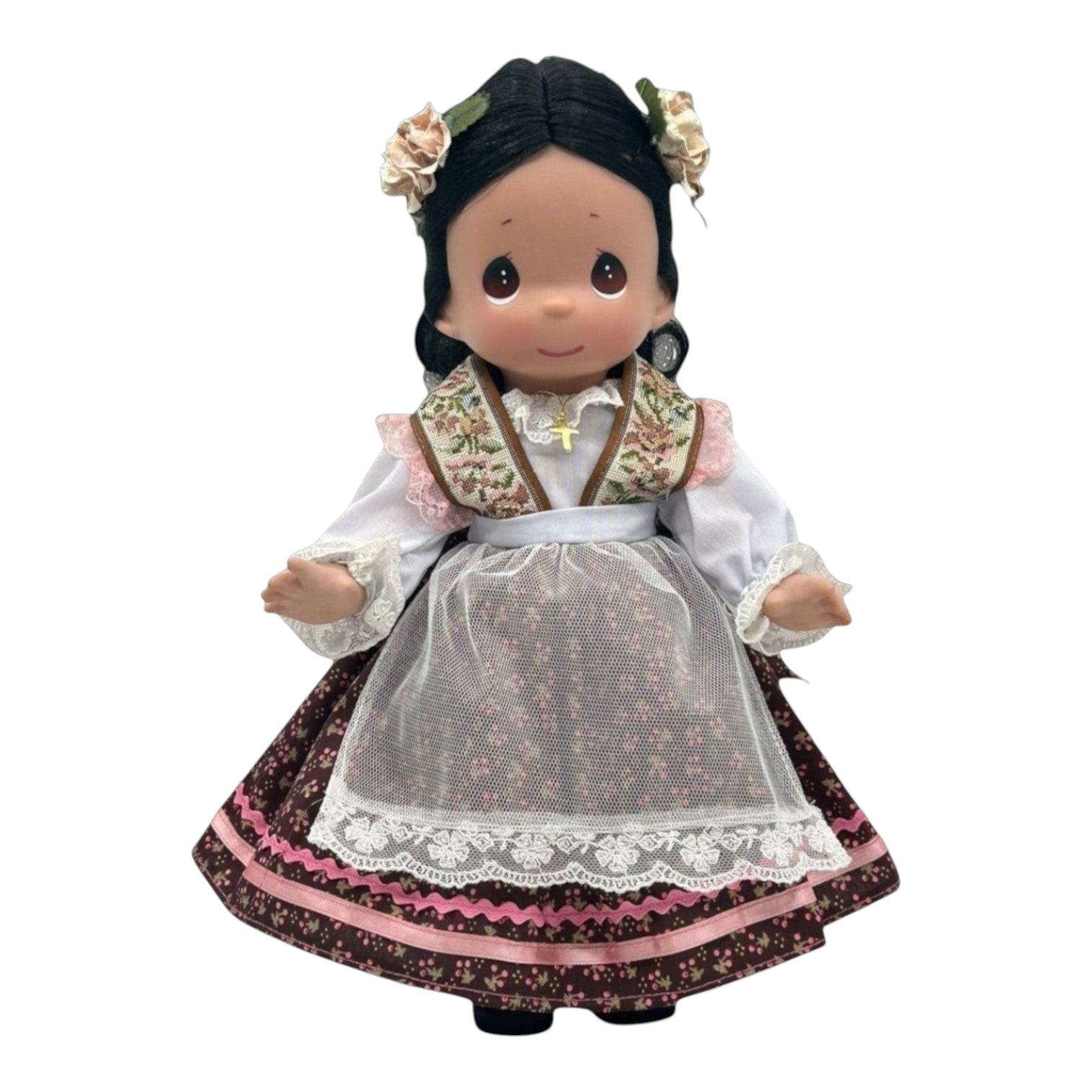 The Doll Maker 12-inch Mexican heritage vinyl doll wearing a traditional floral dress with lace apron and hair flowers.