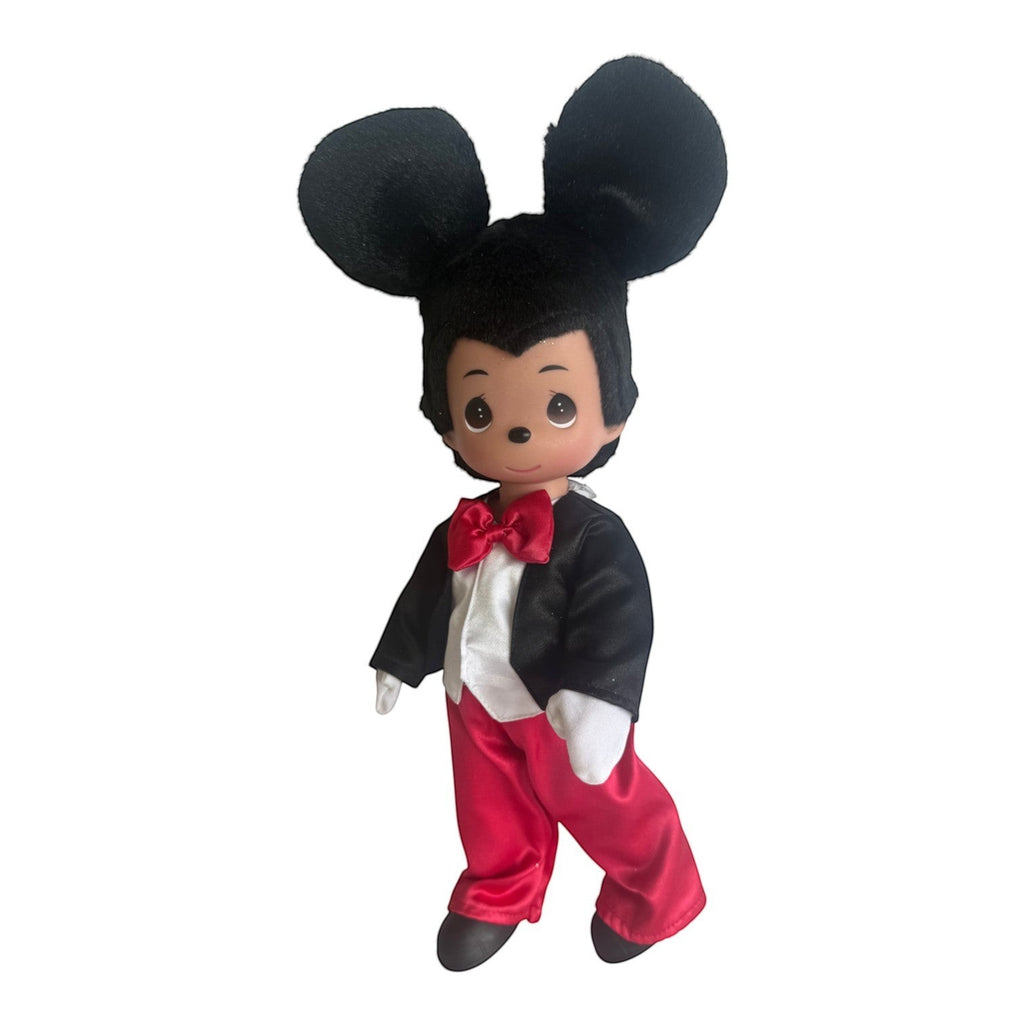 The Doll Maker 12-inch Mickey Mouse vinyl doll wearing a black tuxedo jacket, red trousers, and a red bow tie.