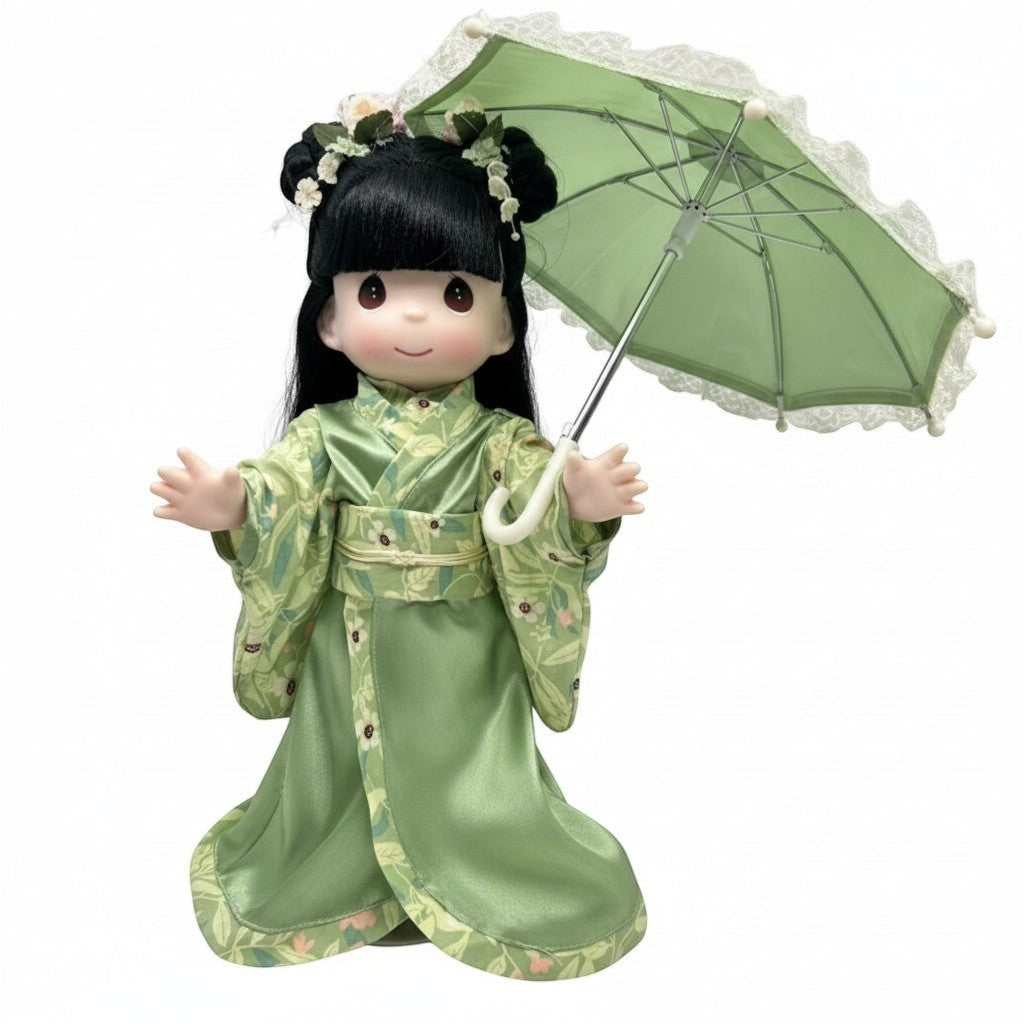 The Doll Maker 12-inch Midori doll wearing a green floral kimono with a matching lace-trimmed parasol.