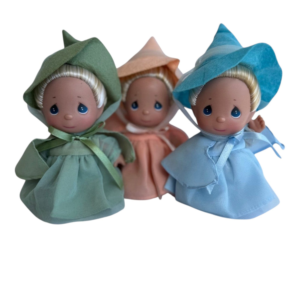 The Doll Maker Mini Sleeping Beauty Fairies set of three 5-inch dolls in green, peach, and blue dresses and hats.