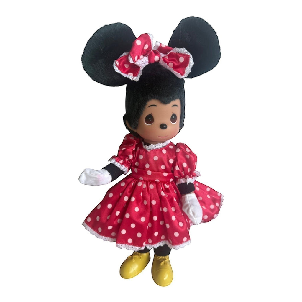 The Doll Maker 12-inch Minnie Mouse vinyl doll wearing a red polka dot dress, white gloves, and yellow shoes.