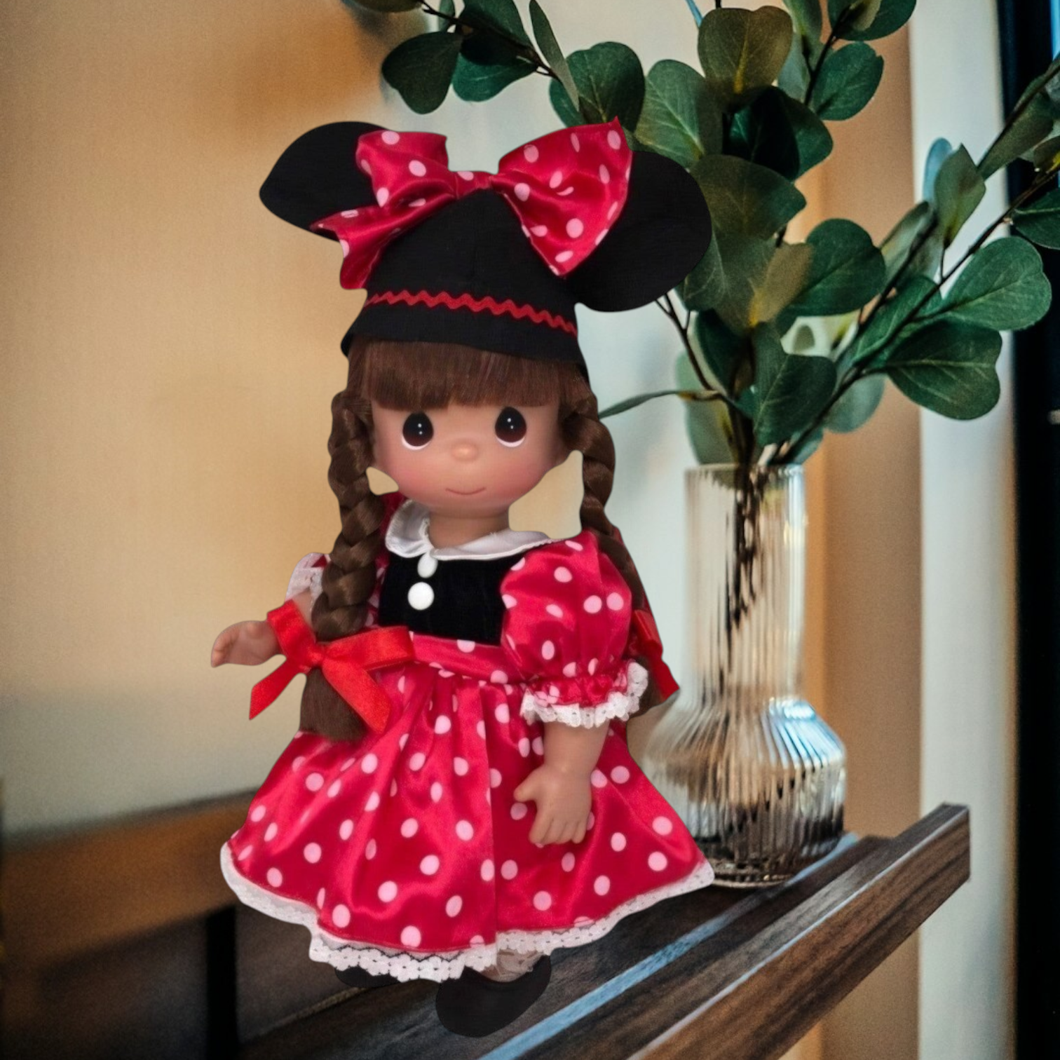 The Doll Maker 12-inch brunette Minnie Mouseketeer doll wearing a red polka dot dress and iconic mouse ear hat.