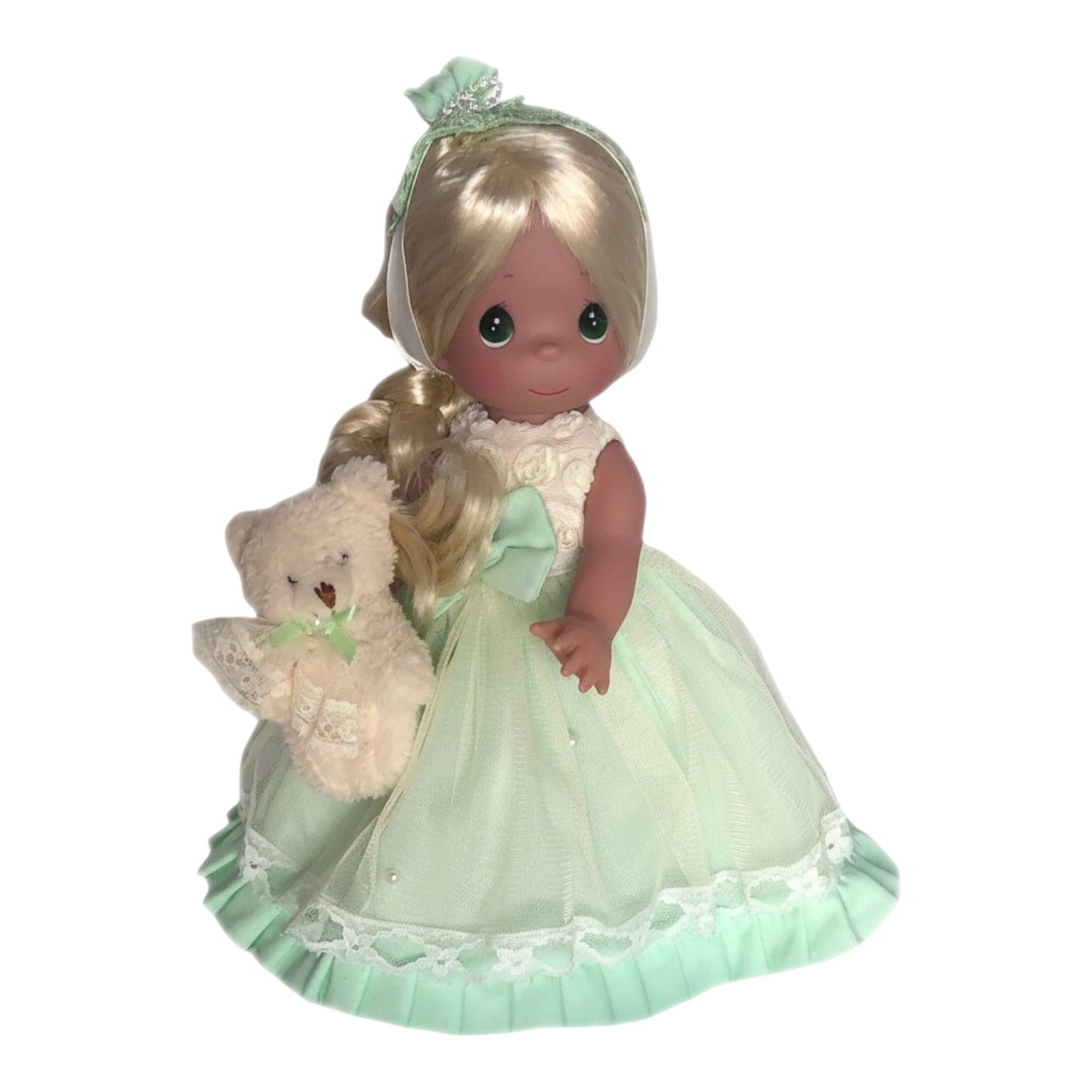 The Doll Maker 12-inch vinyl doll wearing a mint green dress with lace details and holding a small plush teddy bear.