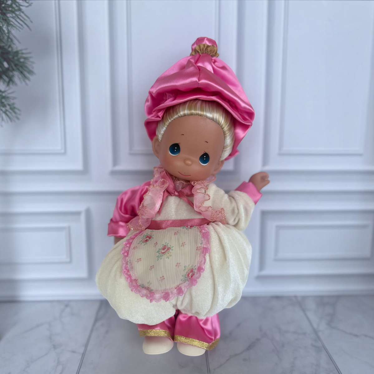 The Doll Maker 12-inch Mrs. Potts collectible doll wearing a pink satin bonnet and cream velvet dress with floral apron