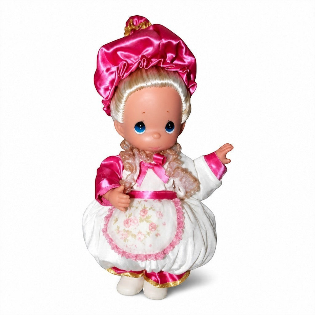 The Doll Maker 12-inch Mrs. Potts doll wearing a white dress with pink floral apron and matching pink satin bonnet.