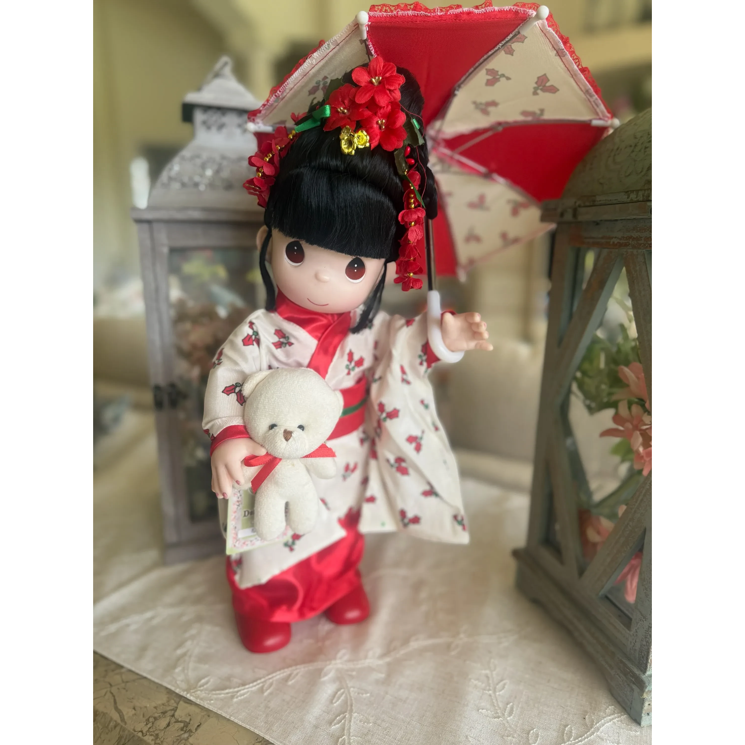 The Doll Maker 16-inch Nodoka Japanese Christmas doll wearing a floral kimono, holding a teddy bear and red umbrella.