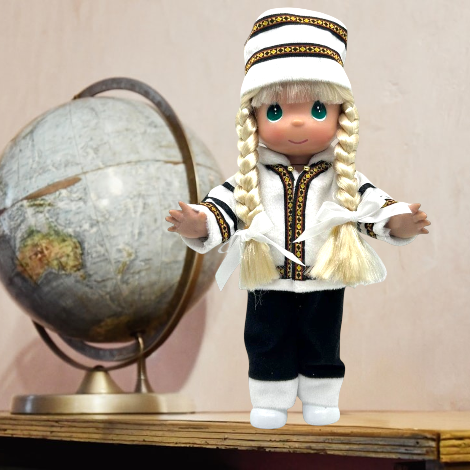 The Doll Maker 12-inch Norwegian doll with blonde braids wearing a traditional white and black Scandinavian costume