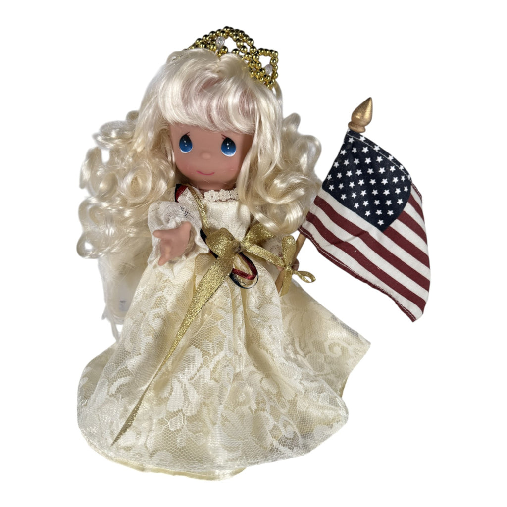 The Doll Maker 9-inch Sweet Liberty patriotic angel doll wearing a lace gown and holding an American flag