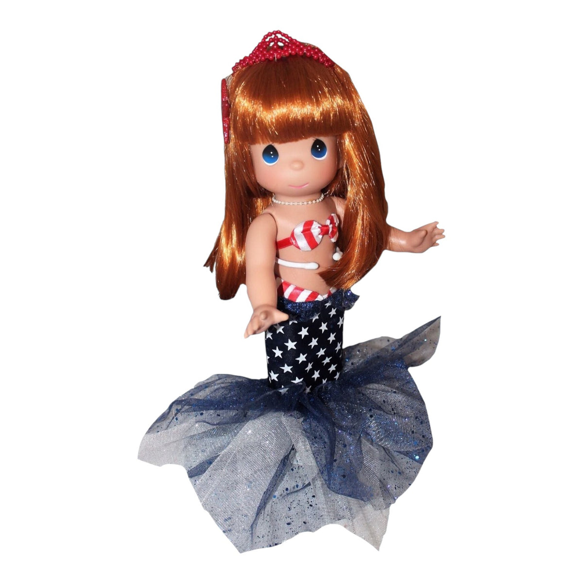 The Doll Maker 12-inch patriotic Ariel mermaid doll with red hair, star-print tail, and red, white, and blue outfit.