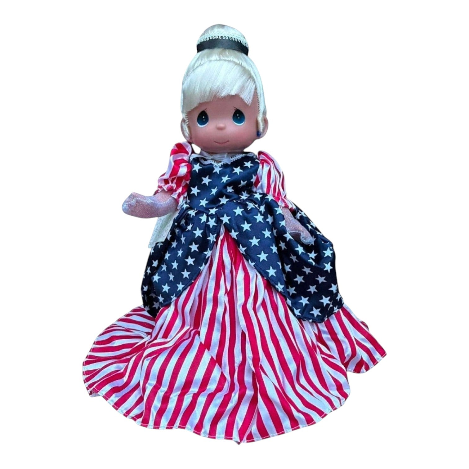 The Doll Maker 12-inch Patriotic Cinderella doll featuring a star-patterned bodice and red and white striped skirt.
