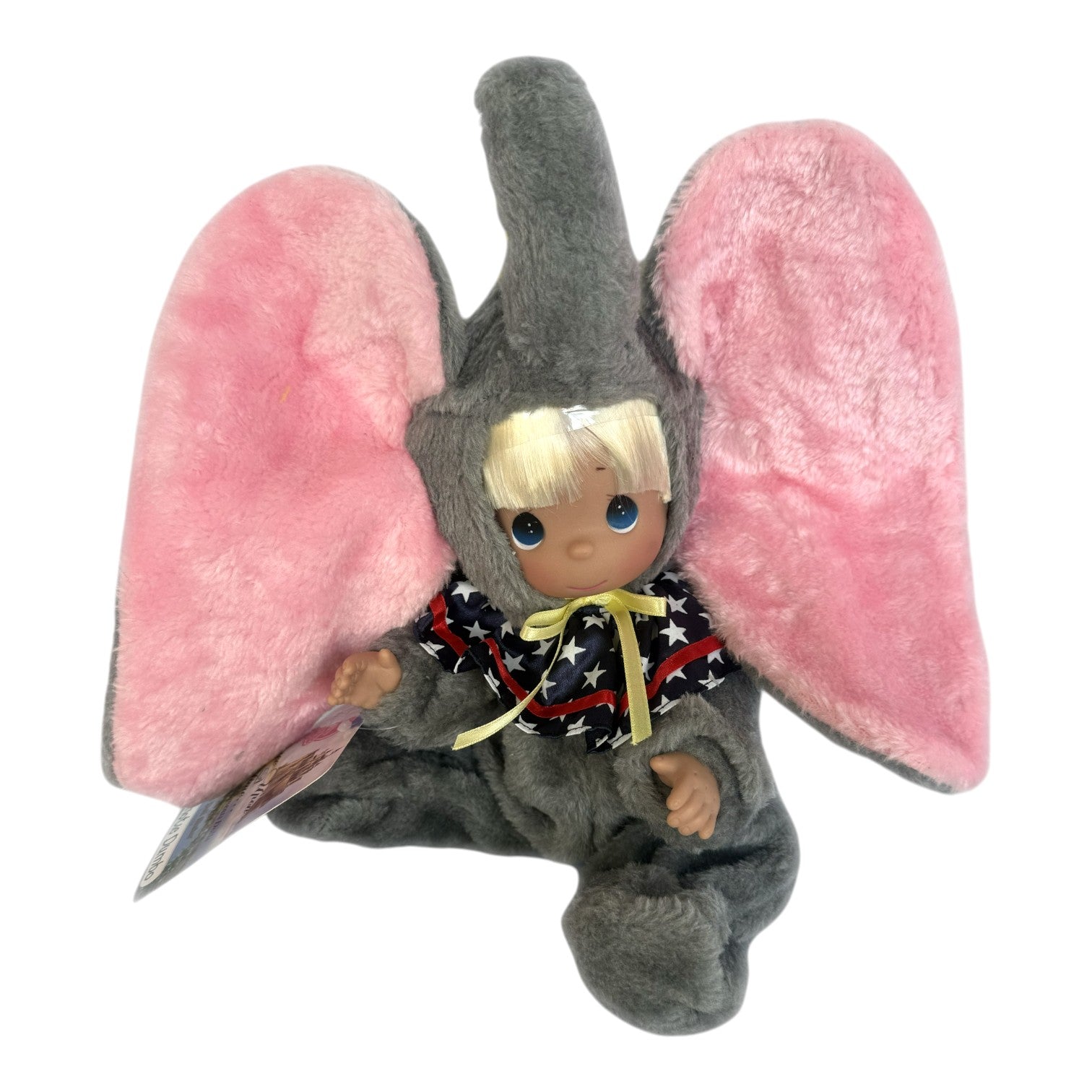 The Doll Maker patriotic Dumbo elephant doll with blonde hair, grey plush suit, and pink ears wearing a star collar.
