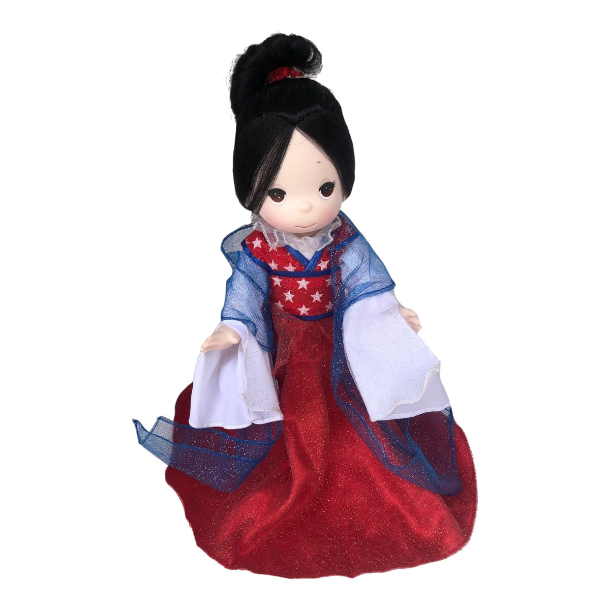 The Doll Maker Patriotic Warrior Mulan 12-inch doll wearing a red dress with white stars and a blue sheer overlay.