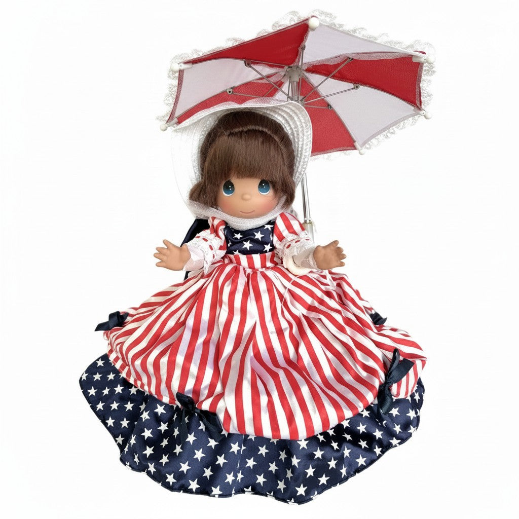 The Doll Maker Patriotic Parasol Girl 12-inch collectible doll wearing a red white and blue star-print dress